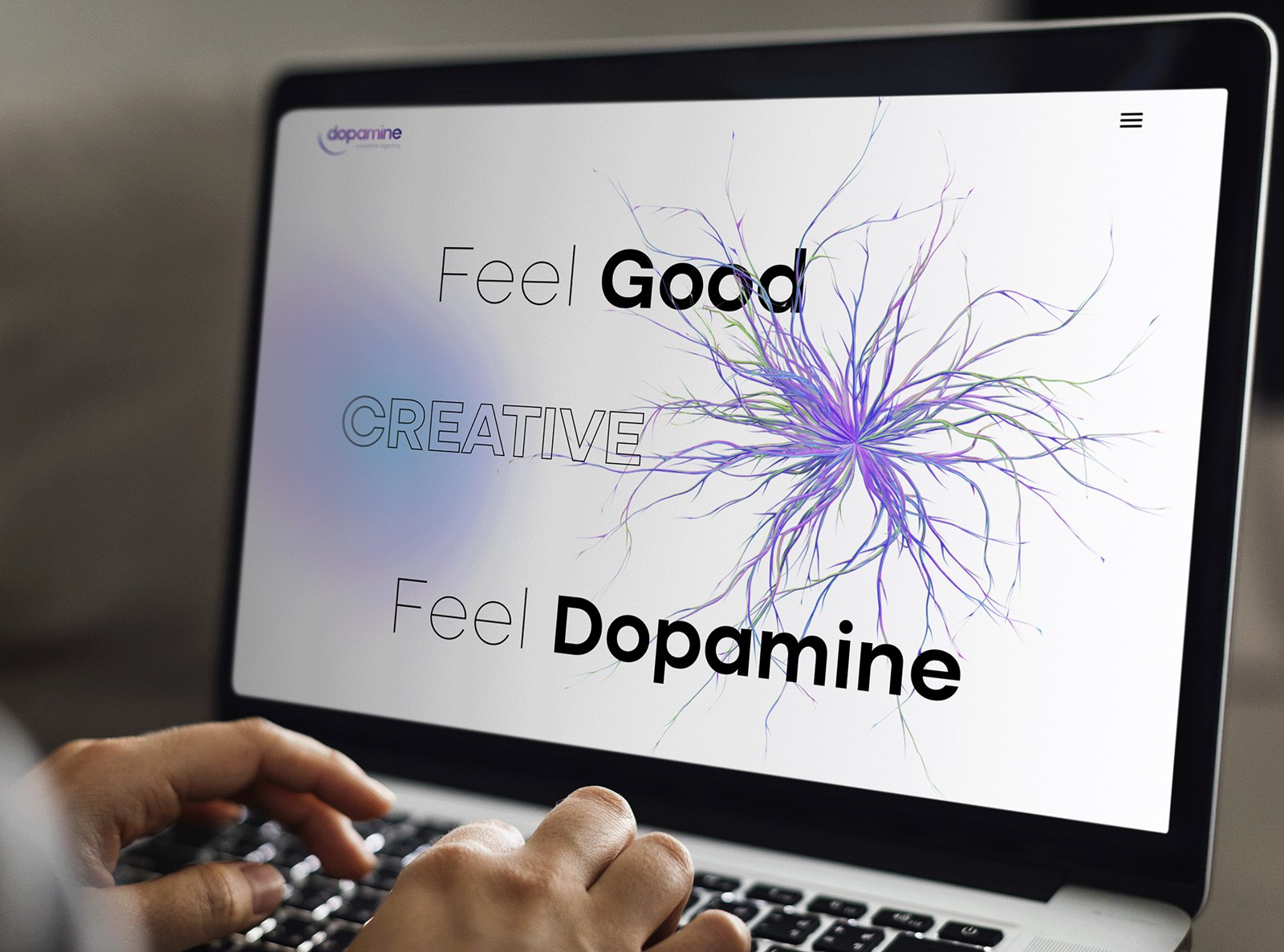 Dopamine creative agency website shown on a laptop